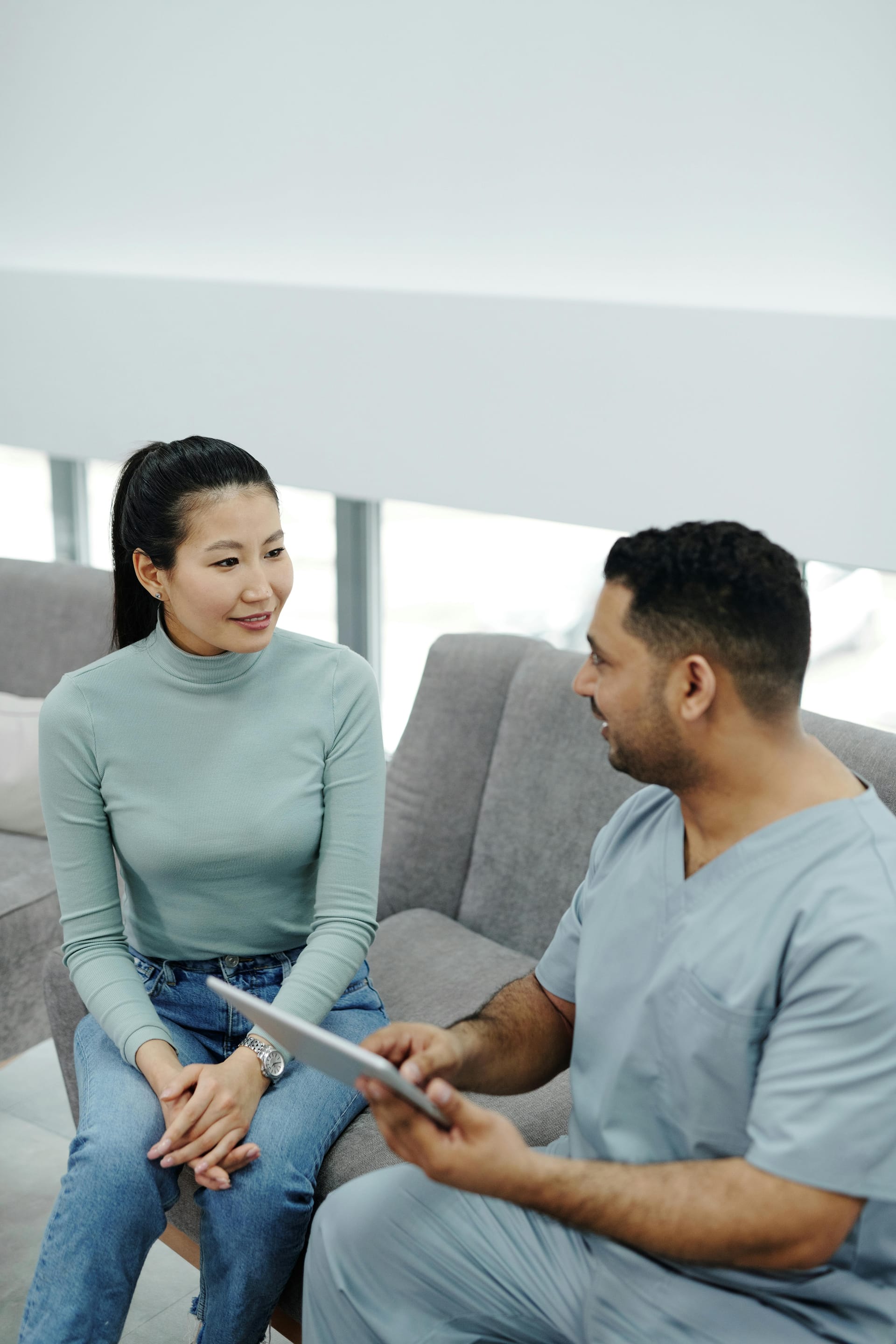 Specialist consulting with patient using tablet