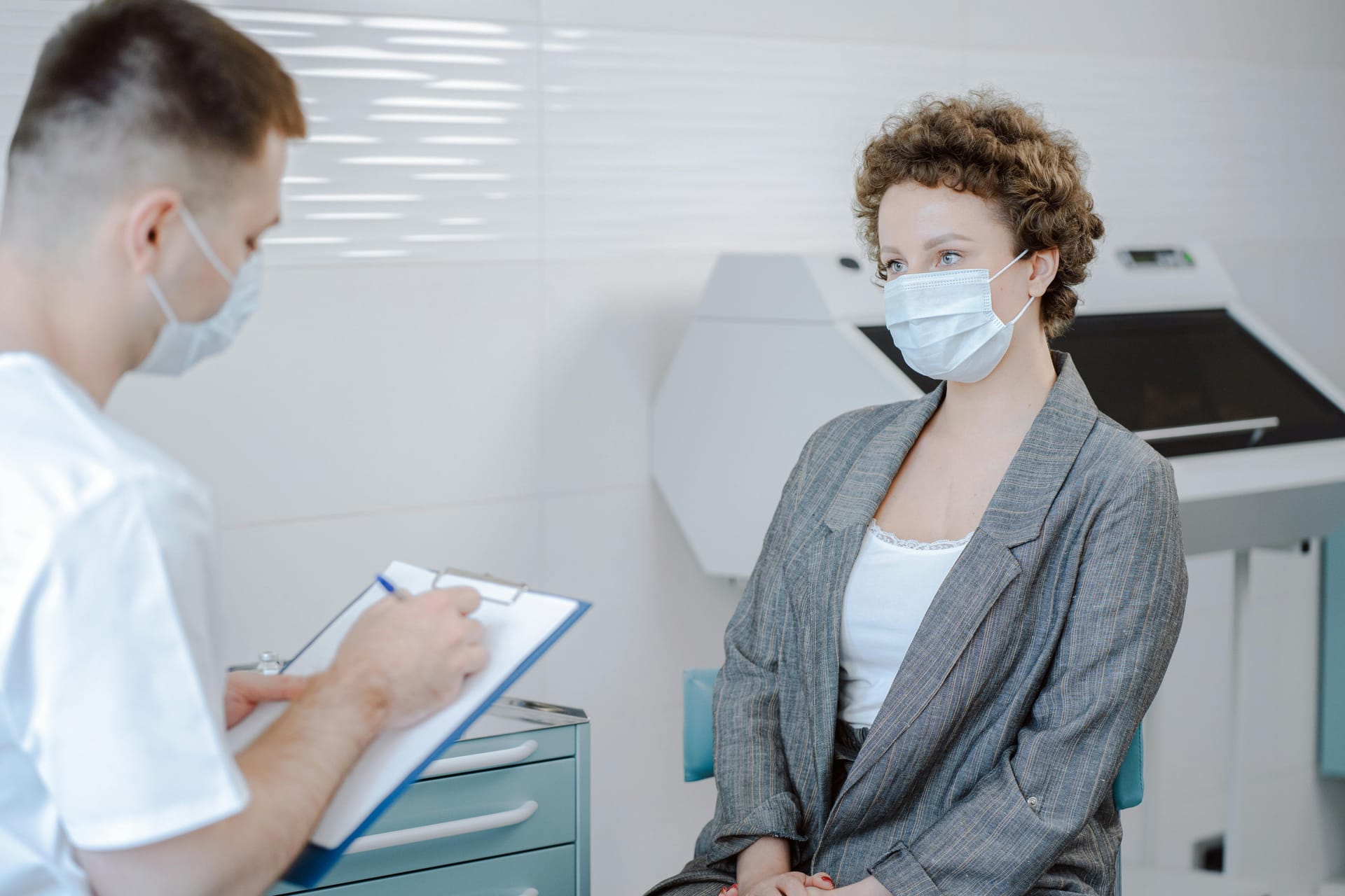 Doctor reviewing patient notes in clinical setting