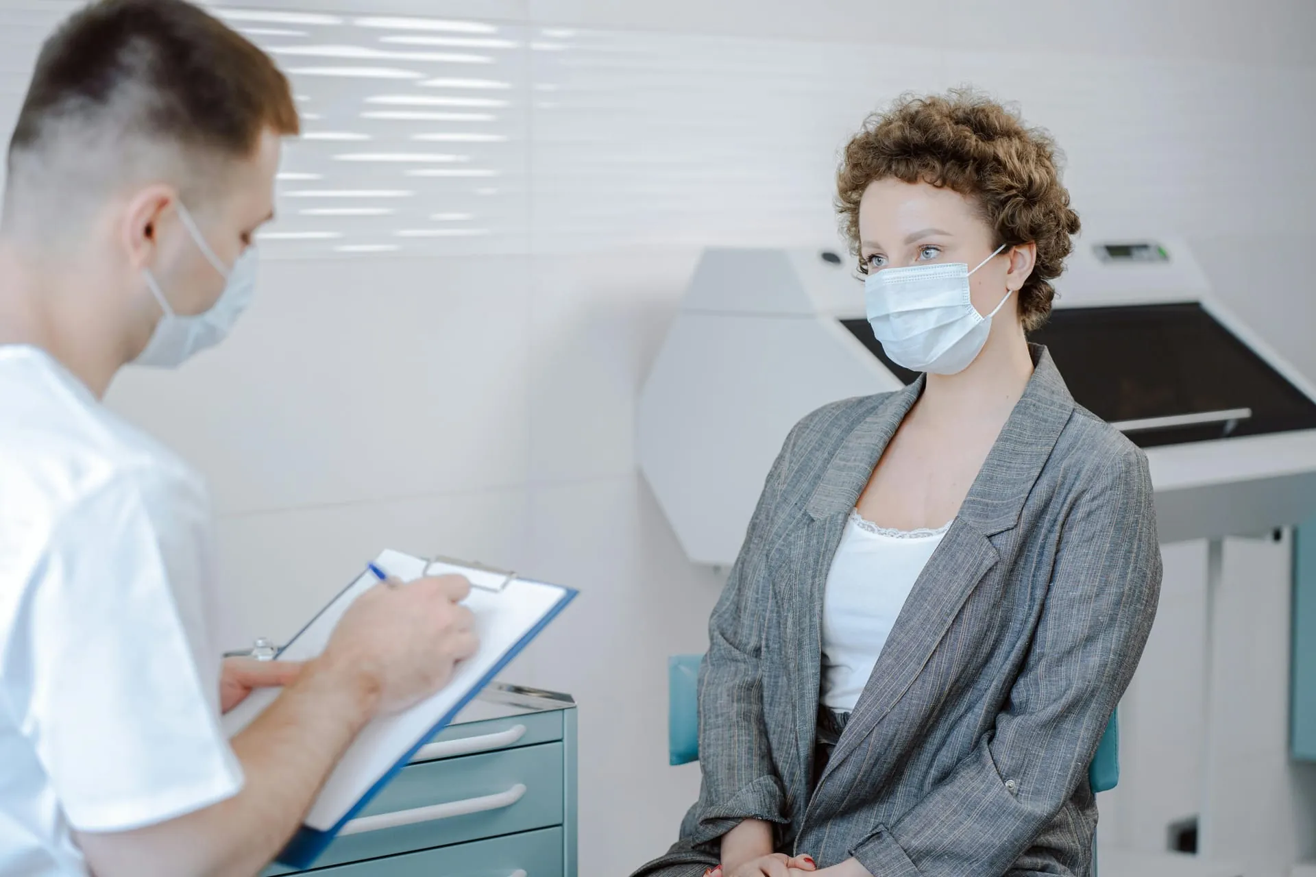 Doctor reviewing patient notes in clinical setting